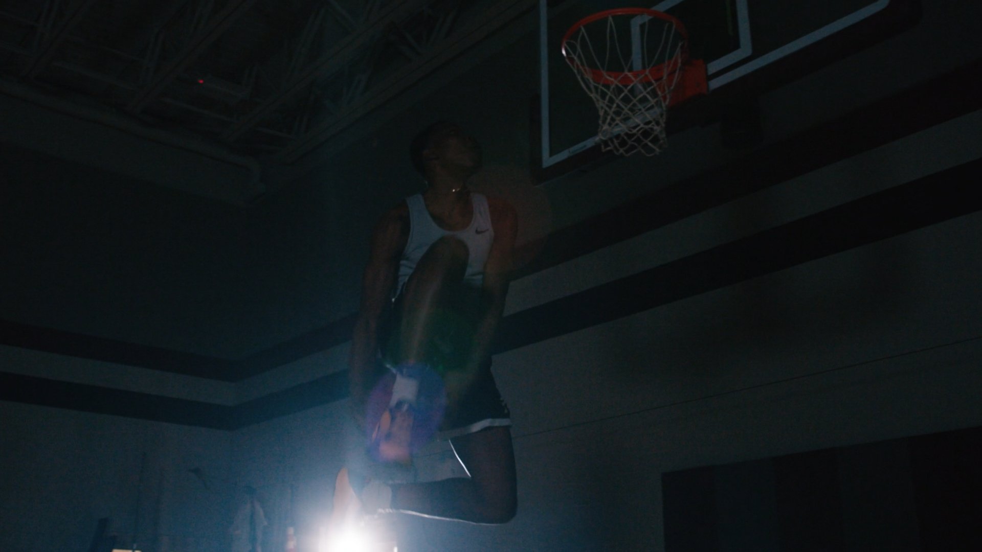 person dunking basketball