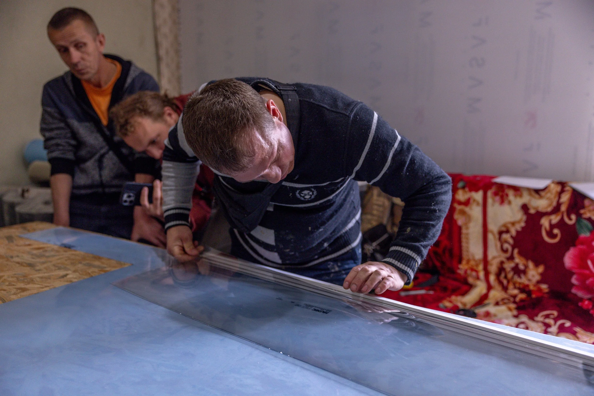 Insulate Ukraine team working on an emergency replacement window