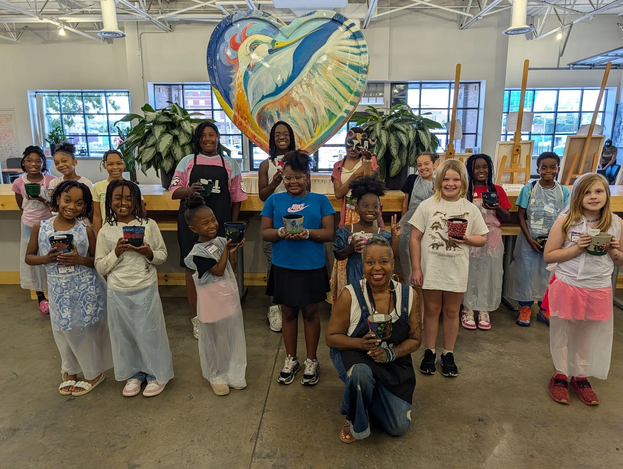 YAI participants and instructors celebrate together with their completed art projects.