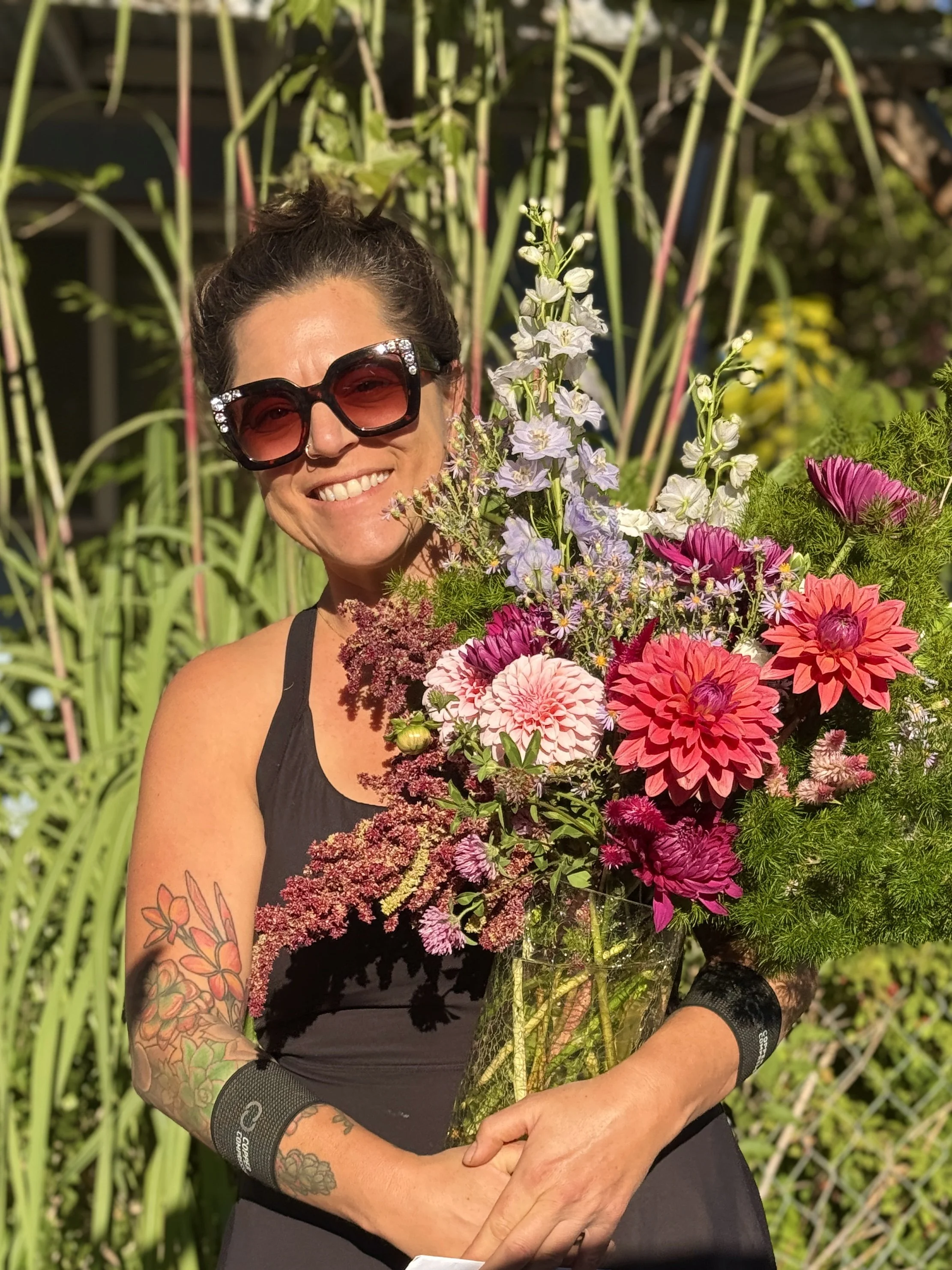 Toni arranging florals at an outdoor ceremony site.