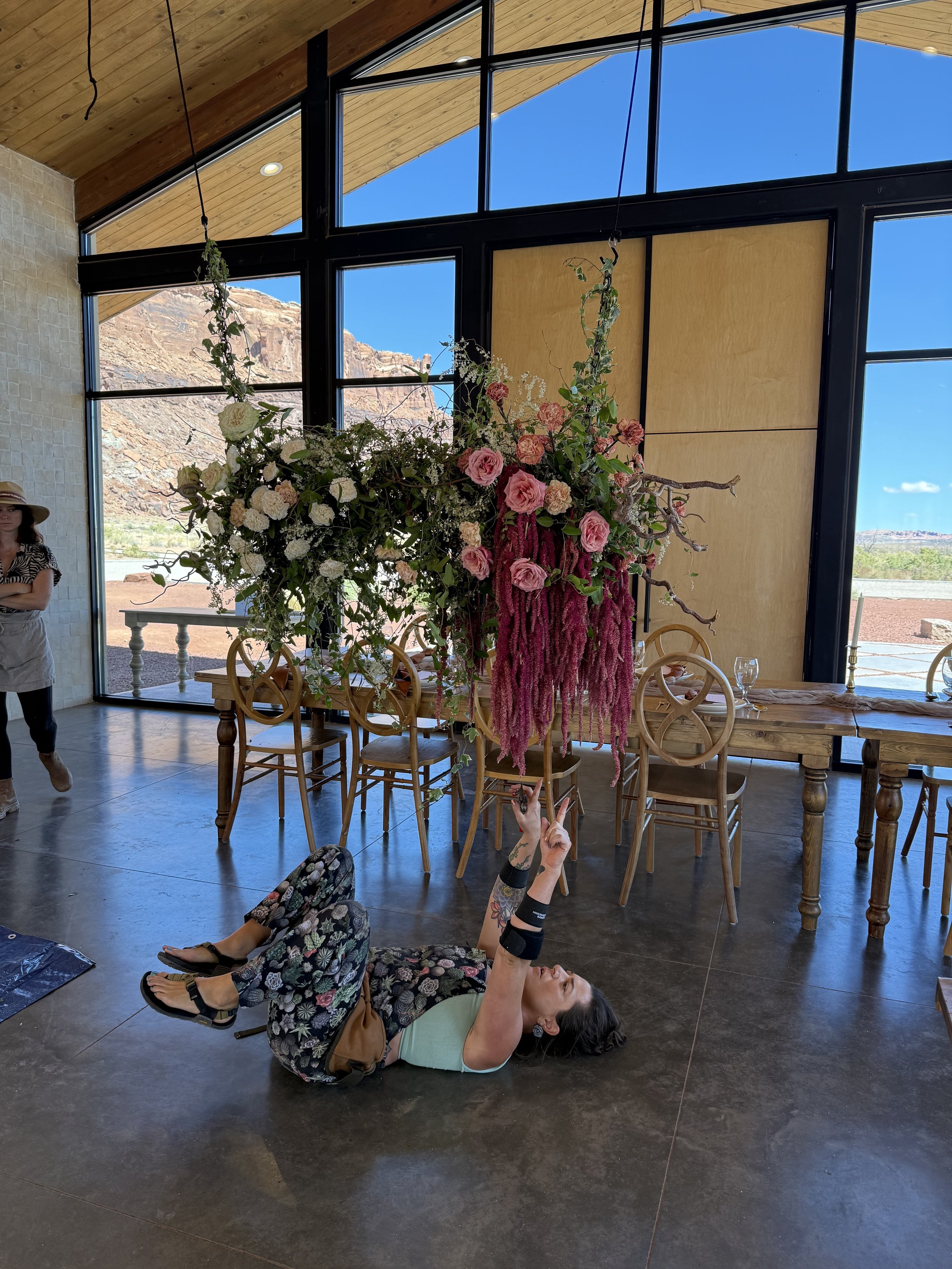 Toni arranging florals at an outdoor ceremony site.