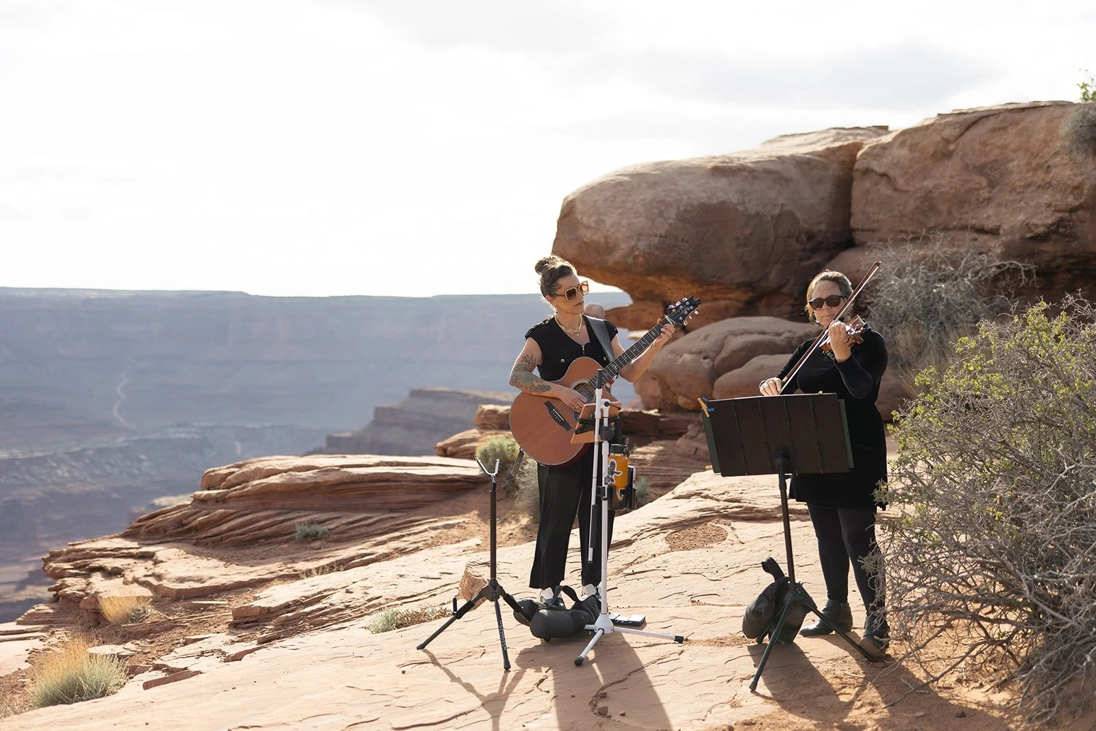 Toni Sicola and a violinist performing wedding music above the Moab canyon