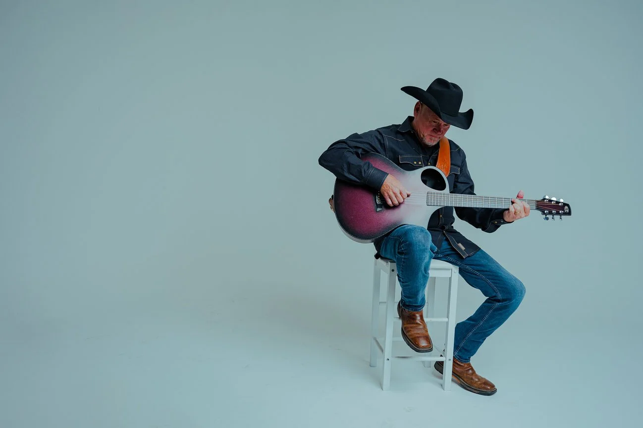 Paul Staggs singer-songwriter playing acoustic guitar, photographed by JME Studios in Tyler Texas