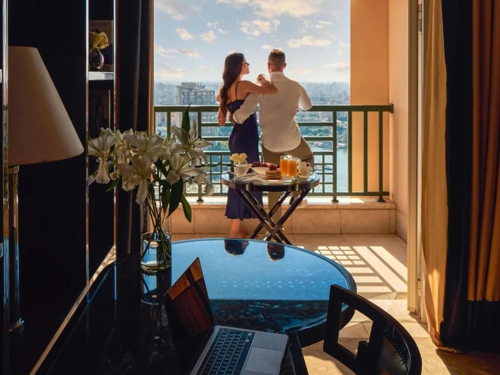 Fairmont Nile City Cairo balcony with Nile River view and city skyline at golden hour