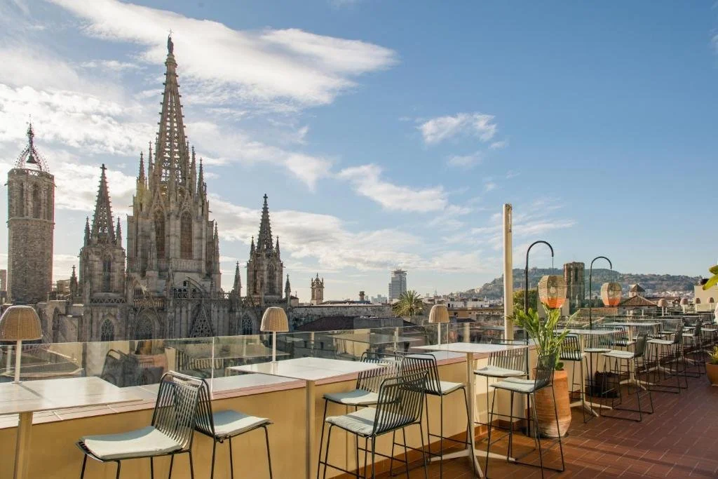 Lamaro Hotel Barcelona L'Àtic rooftop terrace bar with close-range view of Cathedral of Barcelona full Gothic facade and spires