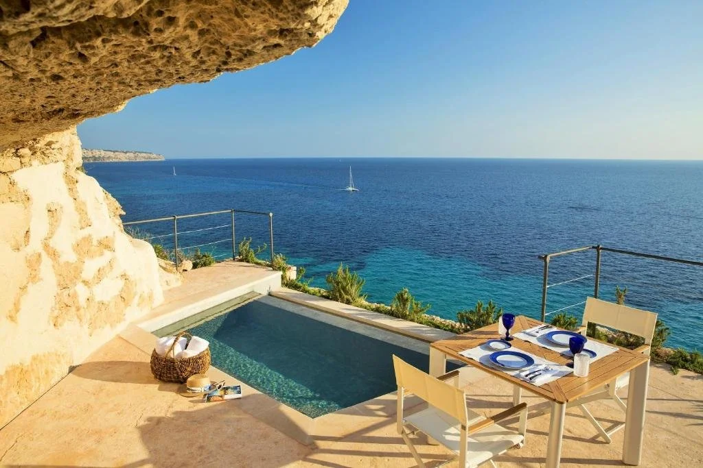 Cap Rocat Mallorca cliff terrace with plunge pool set into golden limestone rock above open Mediterranean sea