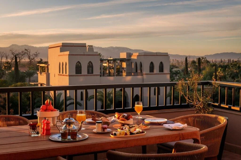 Four Seasons Resort Marrakech breakfast terrace at sunset with Atlas Mountains on the horizon