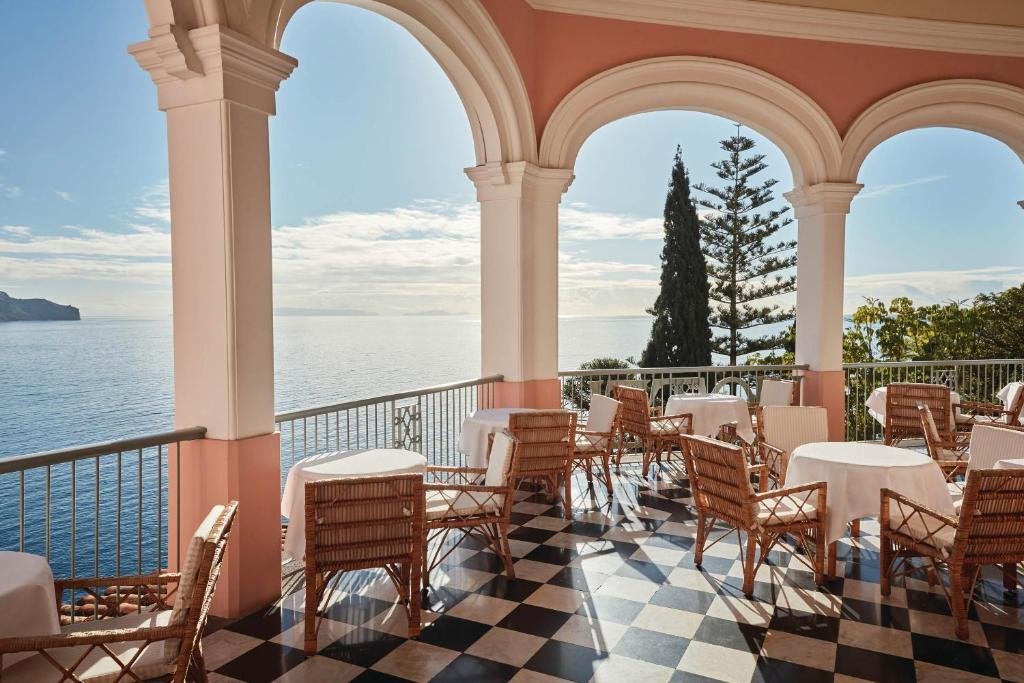 Reid's Palace Belmond Funchal arched terrace restaurant with checkered floor and direct Atlantic Ocean view