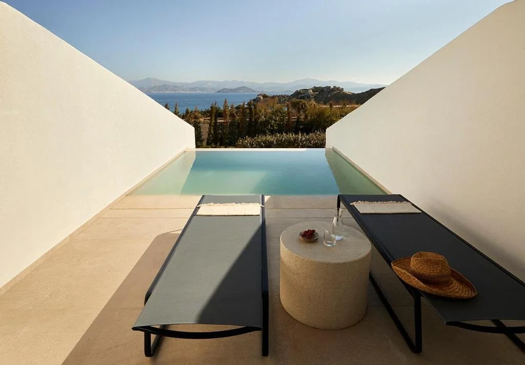 PAROCKS Luxury Hotel Spa Paros private terrace with infinity pool and sun loungers overlooking Aegean Sea and Naxos island mountains