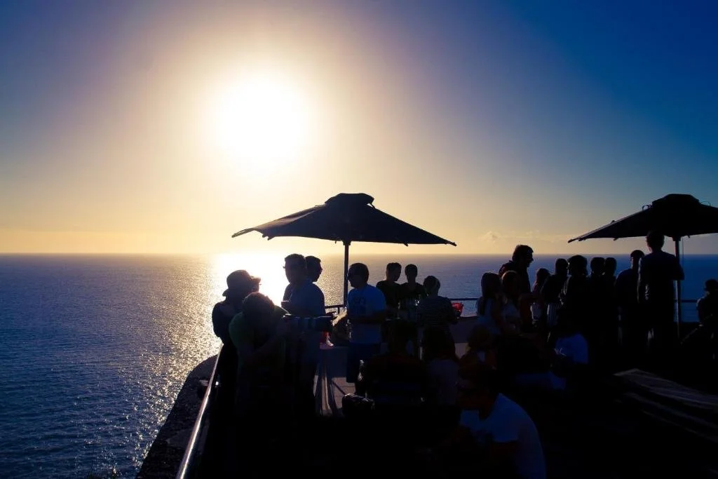 Estalagem da Ponta do Sol Madeira clifftop terrace with guests watching Atlantic sunset, Ponta do Sol
