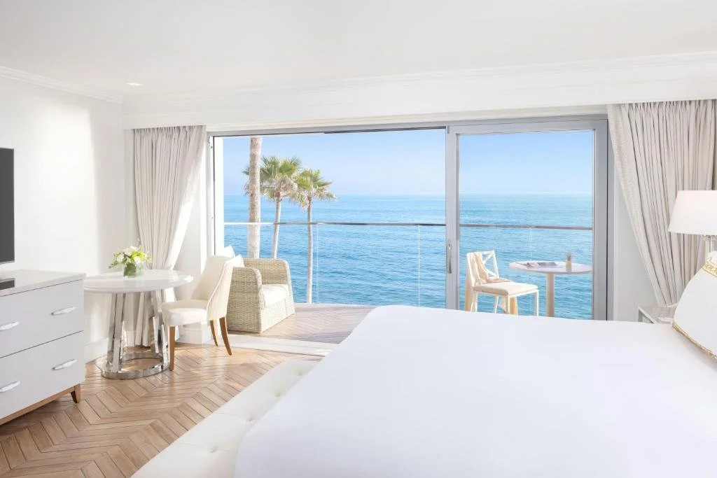 Surf and Sand Laguna Beach ocean-view room with open sliding glass door to balcony directly above the Pacific