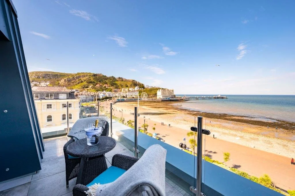 St George’s Hotel Llandudno rooftop terrace with glass balustrade overlooking North Shore beach, pier and Great Orme headland