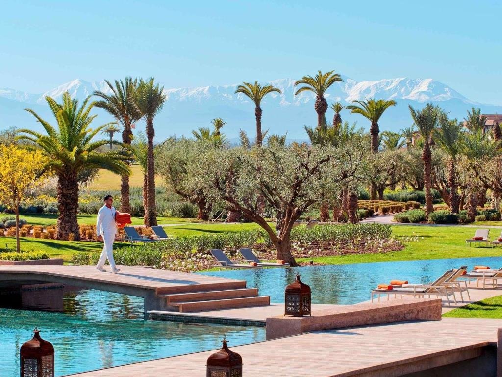 Fairmont Royal Palm Marrakech pool terrace and gardens with snow-capped Atlas Mountains