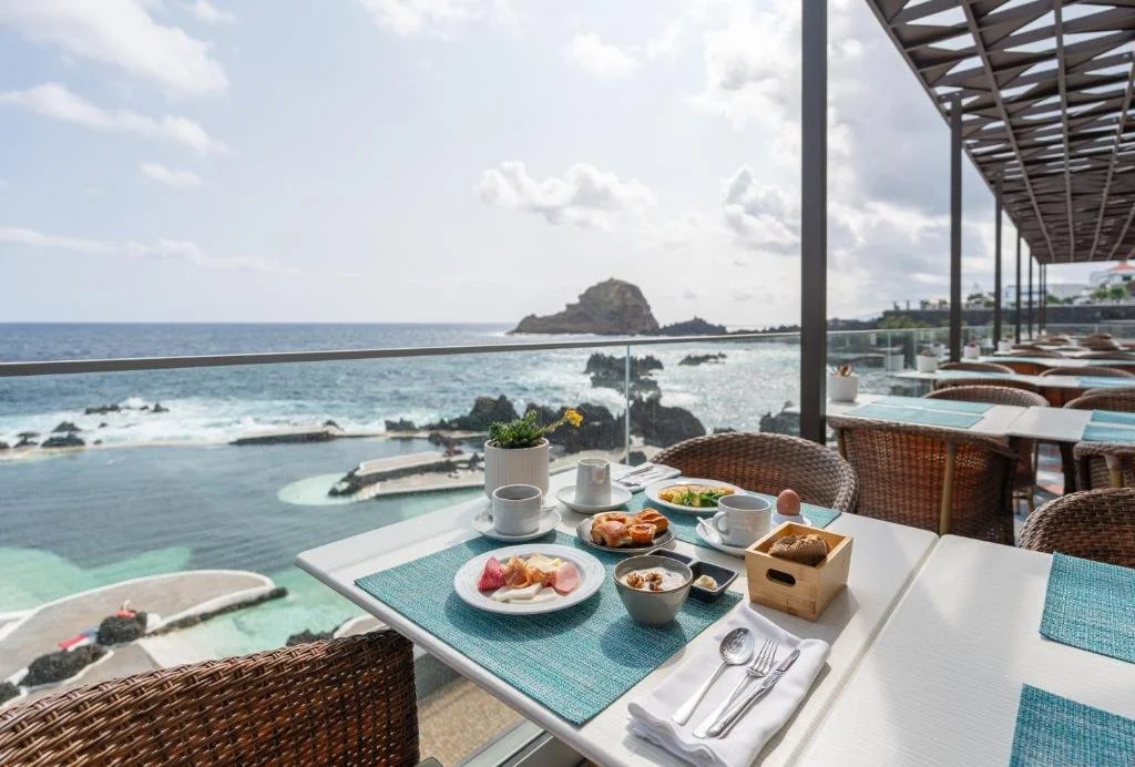 Aqua Natura Madeira Porto Moniz restaurant terrace overlooking natural lava pools and Atlantic Ocean