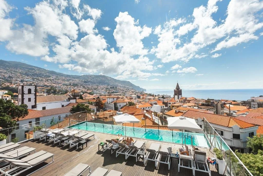 Castanheiro Boutique Hotel Funchal rooftop infinity pool with panoramic view over the historic center and Funchal Cathedral tower