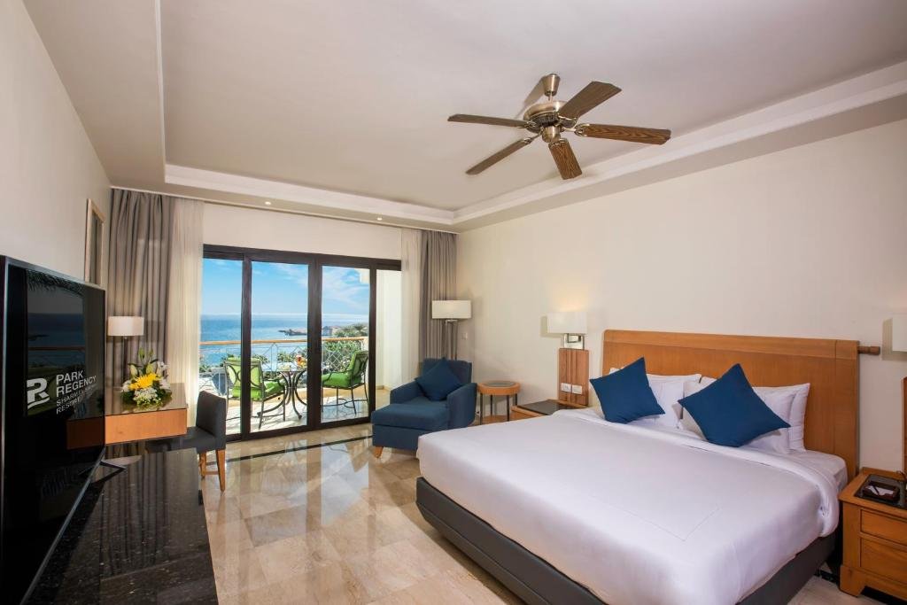 Park Regency Sharm El Sheikh Resort king room with glass doors opening to a sea-view balcony