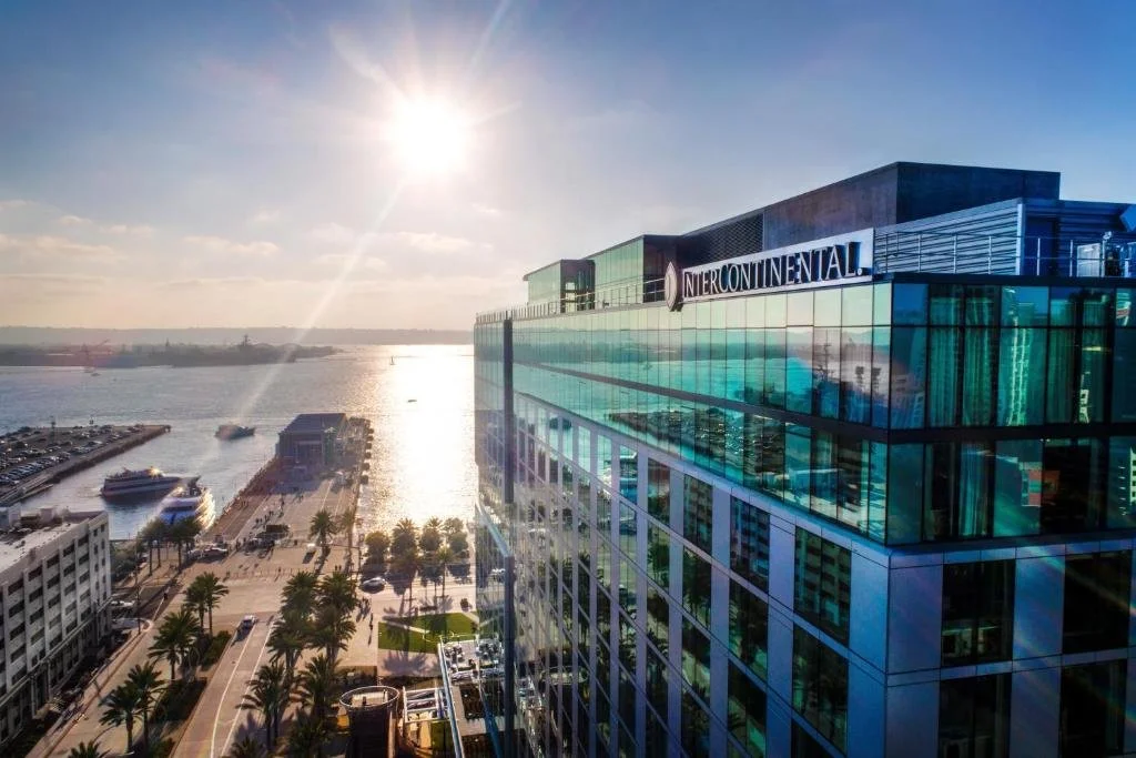 InterContinental San Diego glass tower exterior with Embarcadero waterfront and San Diego Bay at sunset