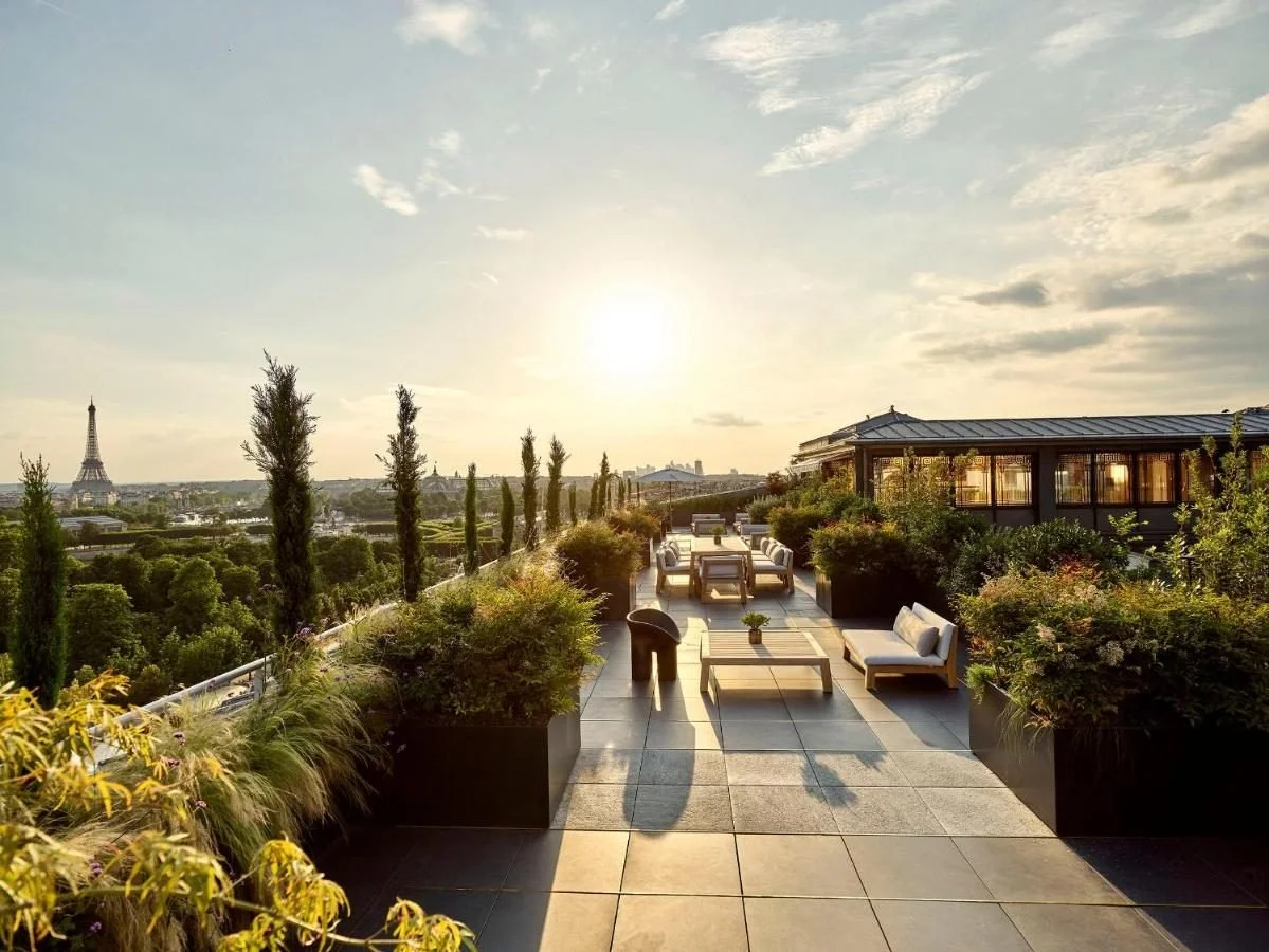 Le Meurice — rooftop terrace at dusk with the Eiffel Tower and Paris panorama