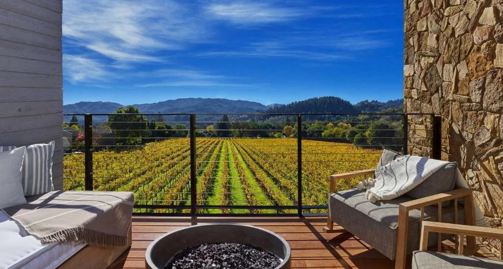 Alila Napa Valley St Helena private balcony with fire pit overlooking autumn gold vineyard rows and wooded hills