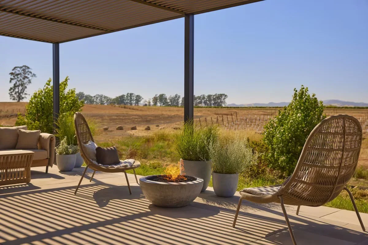 Stanly Ranch Auberge Collection Napa outdoor terrace with fire bowl and open ranch and vineyard view