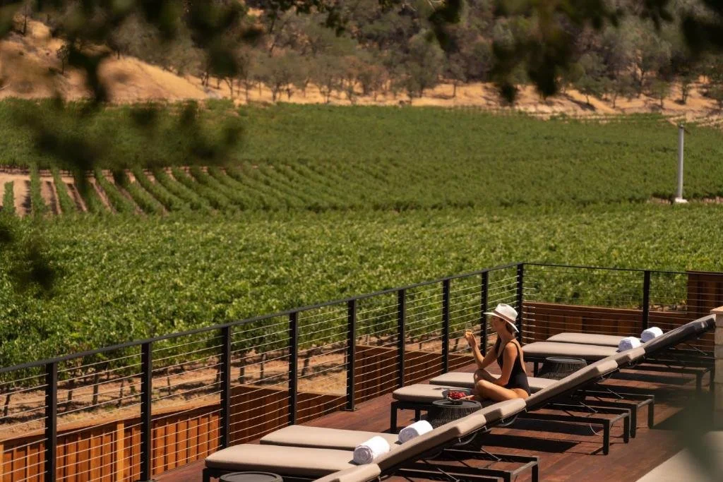 Four Seasons Resort Napa Valley Calistoga terrace and lounge chairs directly above adjacent vineyard rows