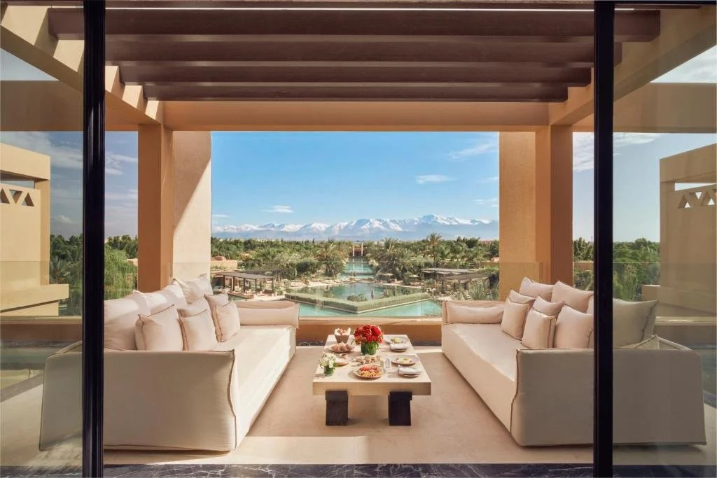 Mandarin Oriental Marrakech suite terrace with view over the resort pool and snow-capped Atlas Mountains