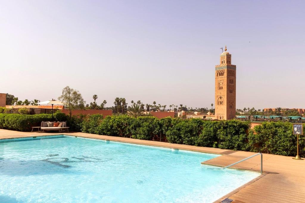 Les Jardins de la Koutoubia Marrakech outdoor pool with the Koutoubia Mosque minaret rising to the right