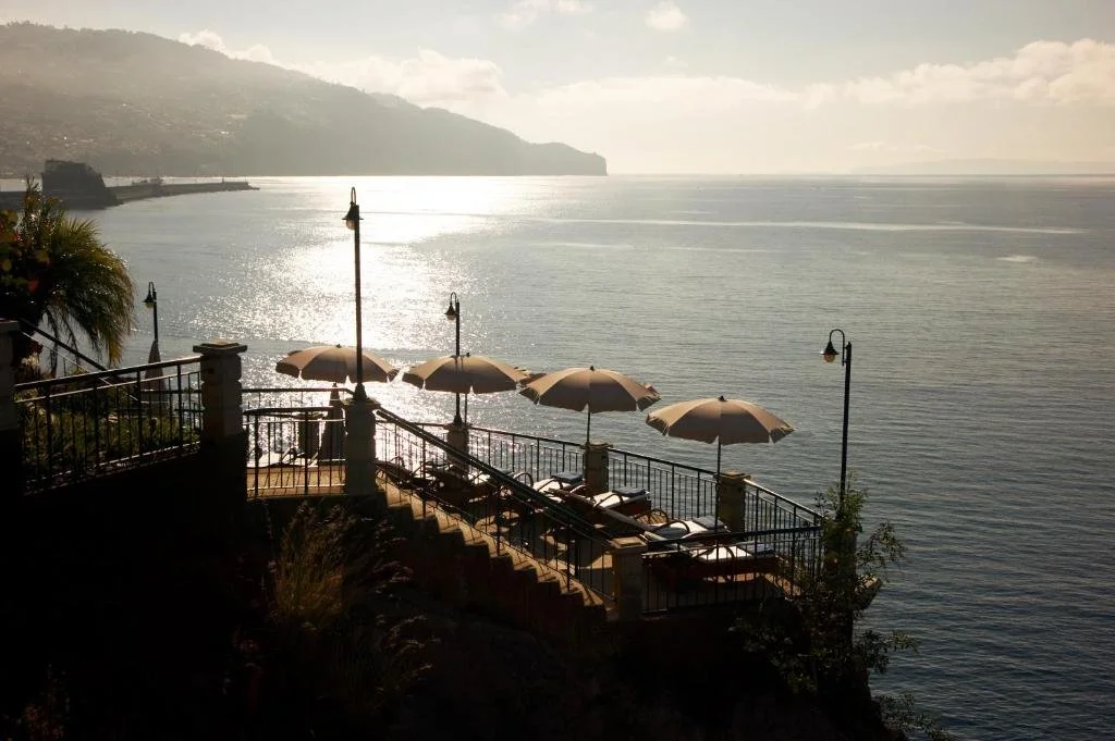 Hotel The Cliff Bay Funchal cliffside sundeck terraces with parasols overlooking Funchal Bay and the Atlantic
