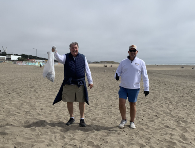 Luster team members at a community beach cleanup