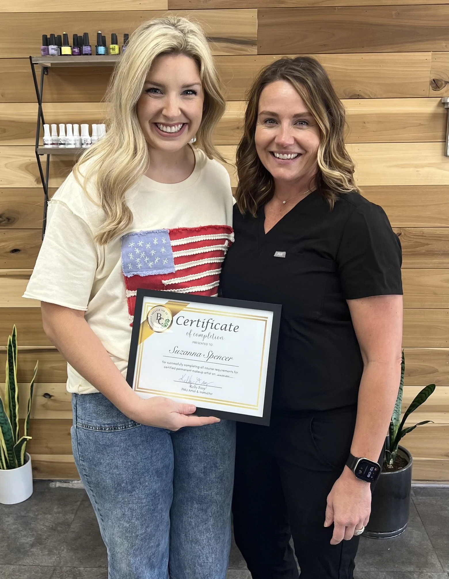 Kelly Frey presenting a permanent makeup certification to a graduating student at Beautifully Created Ink Co. in Paris, Tennessee