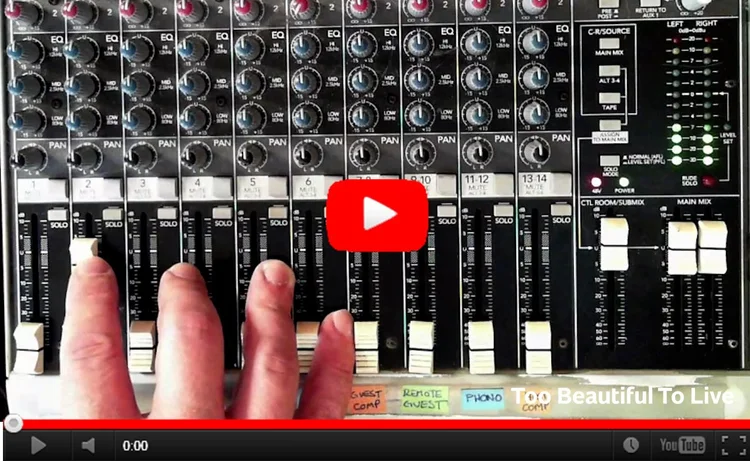 YouTube still image of an audio board with Andrew's four fingers on the sliders