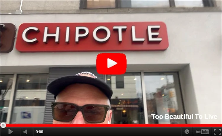 YouTube still image of Luke standing in front of a Chipotle. We just see half of Luke's face - his sunglasses and hat - with the Chipotle sign high up behind him.