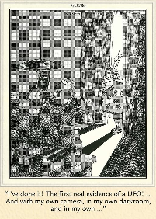 Cartoon showing boy in darkroom holding a print up while his mom opens the door behind him, letting in light. Caption: I’ve done it! The first real evidence of a UFO! … And with my own camera, in my own darkroom, and in my own..."