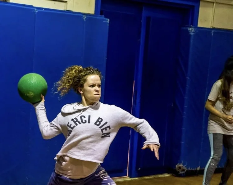 Photo of listener Adrienne making a VERY INTENSE face as she gets ready to whip a dodgeball at someone