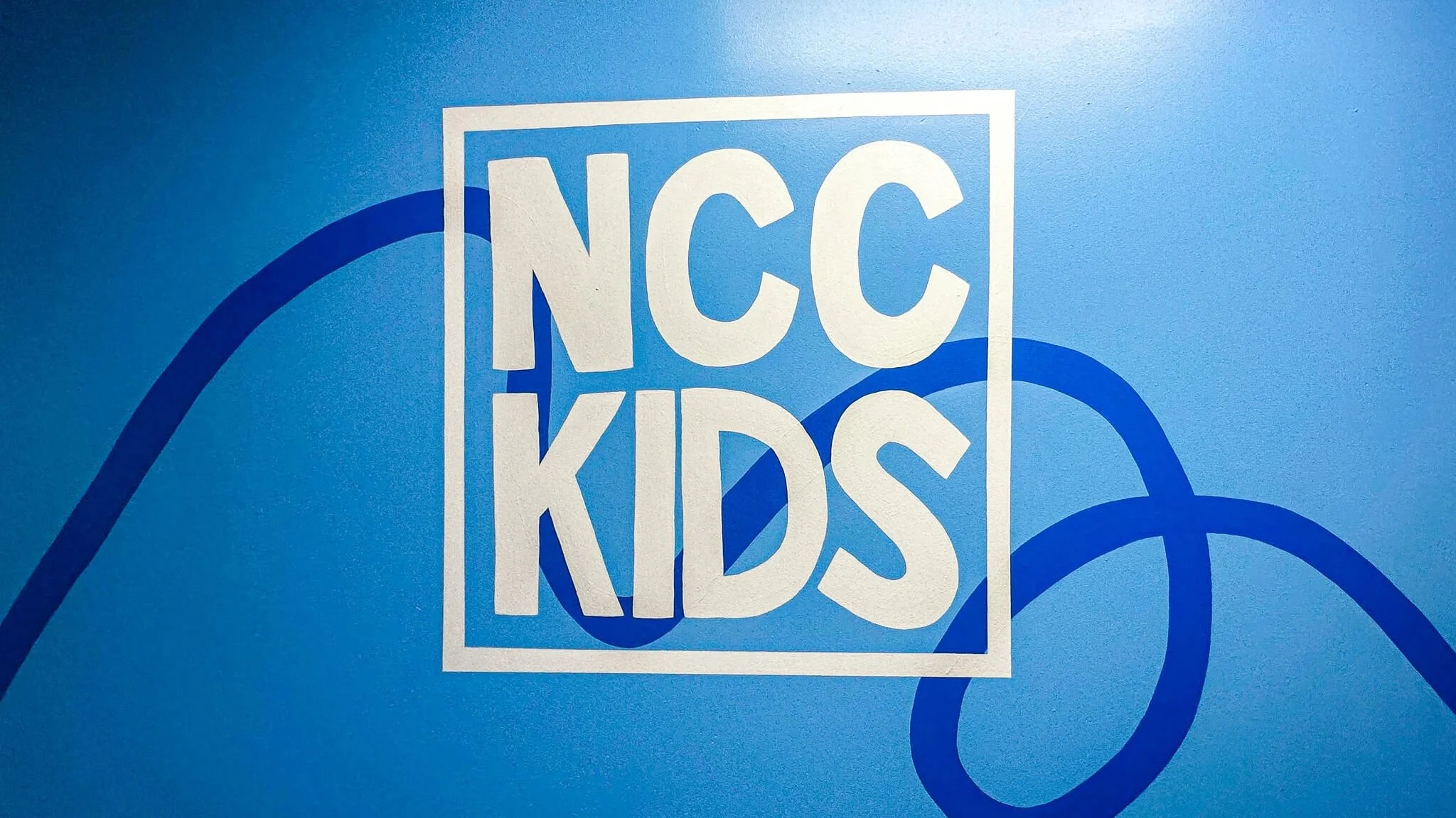 Hand-painted kids ministry hallway mural