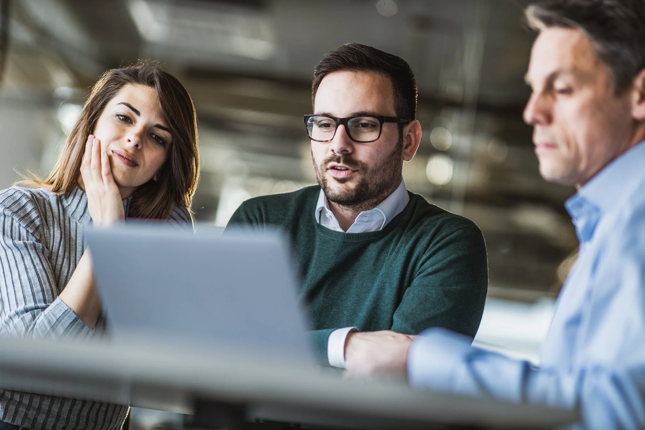 Three people reviewing life insurance documents together