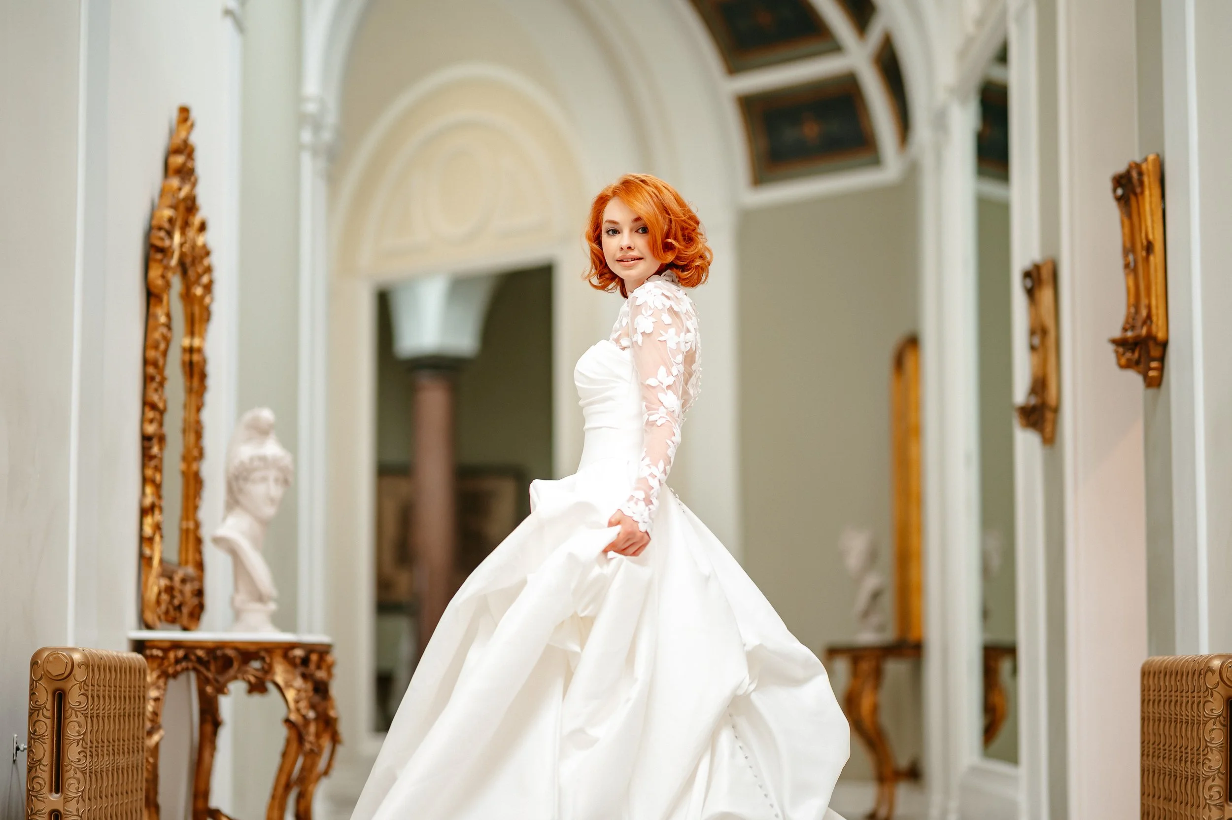 Bride walking down a grand entrance hallway, Lartington Hall.