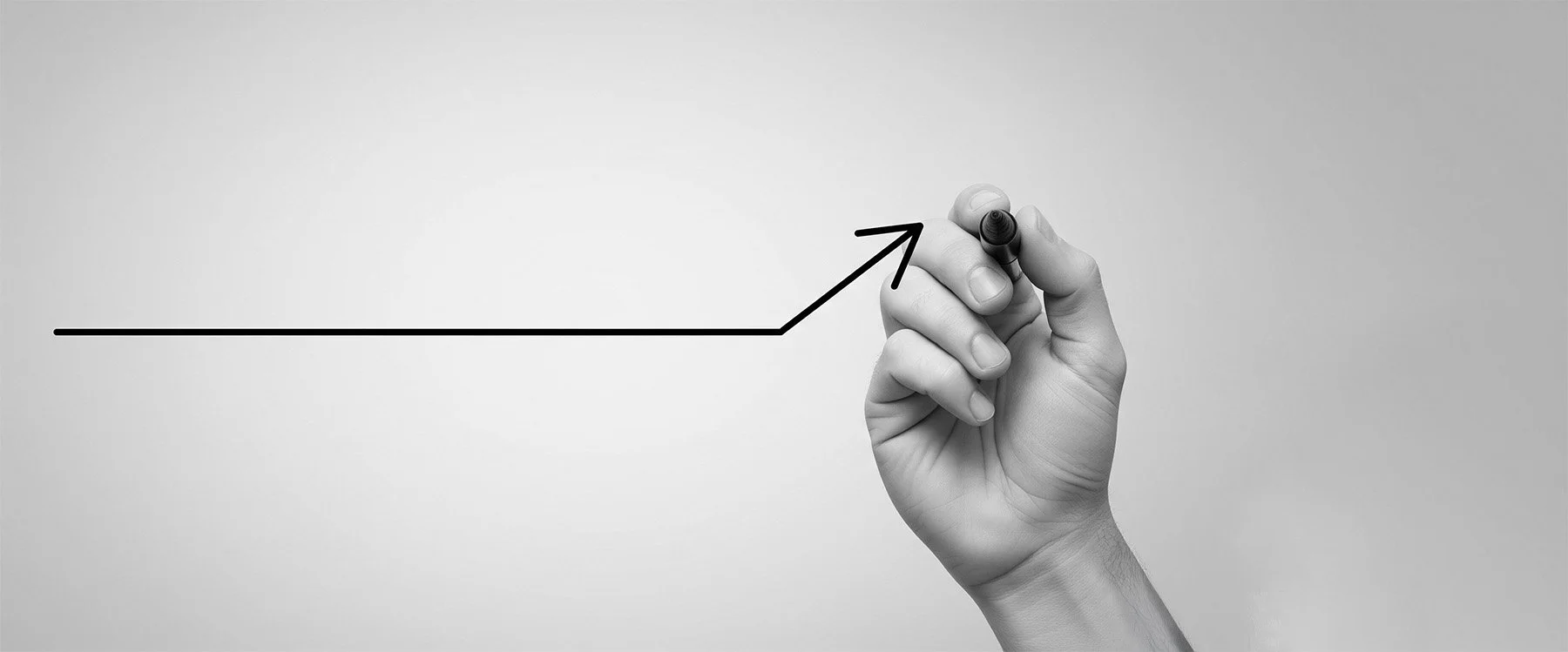 A hand drawing a strategic growth arrow, representing consulting services.