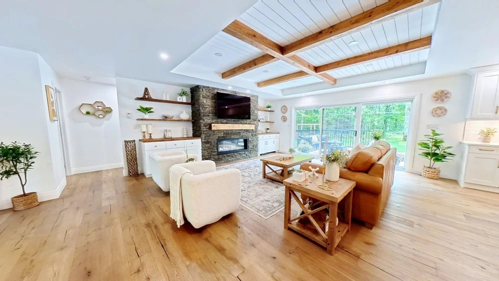 Matterport scan of an open-concept living room with beamed ceiling and fireplace