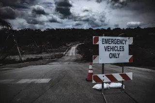 A sign at a flood site reads Emergency Vehicles Only.