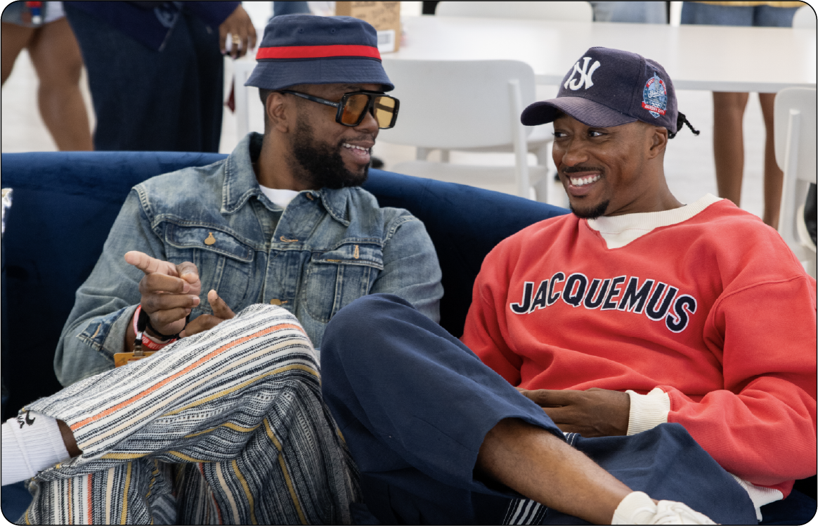 Two attendees talking on a couch in the Career Lounge