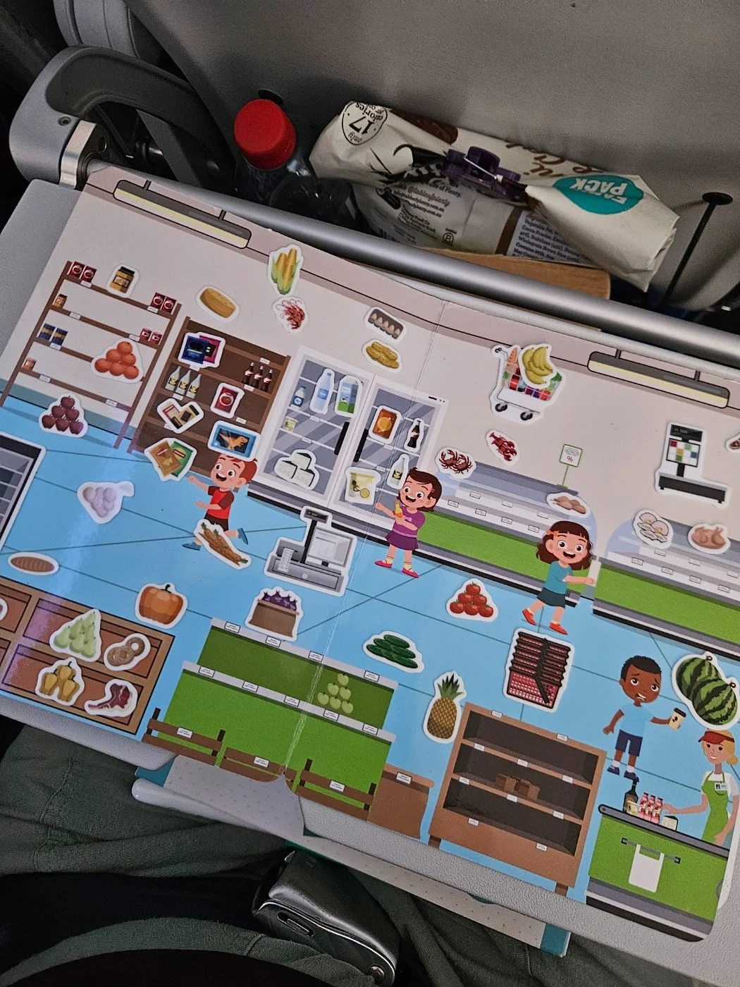 A reusable sticker scene on a plane tray table