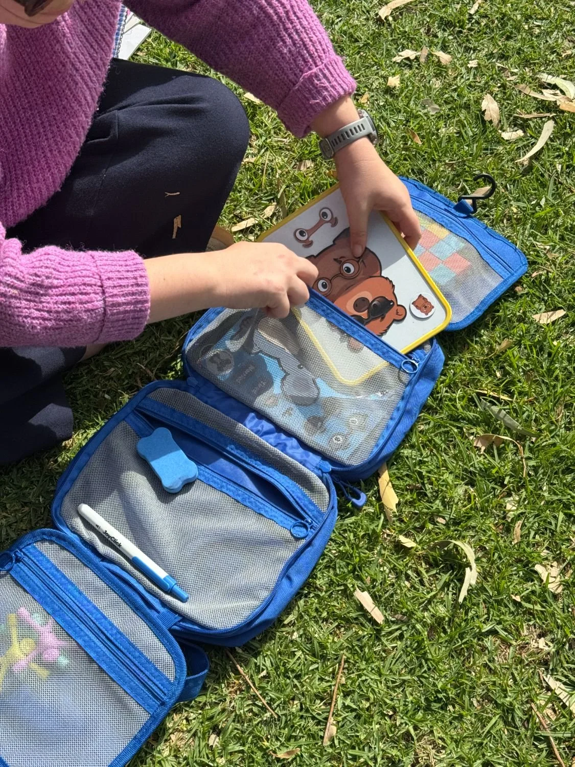 The emotion magnet board sliding into its zip pocket in the travel kit