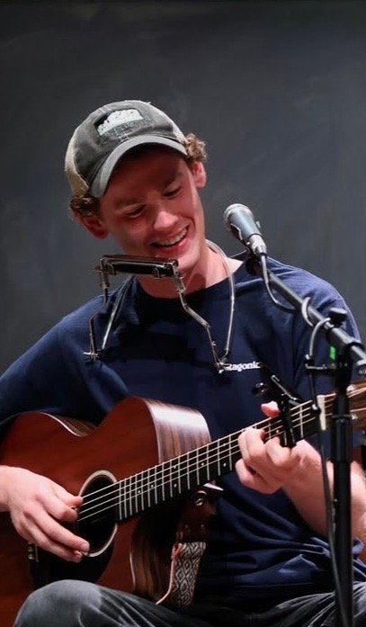 Hank Monnig singing and playing acoustic guitar