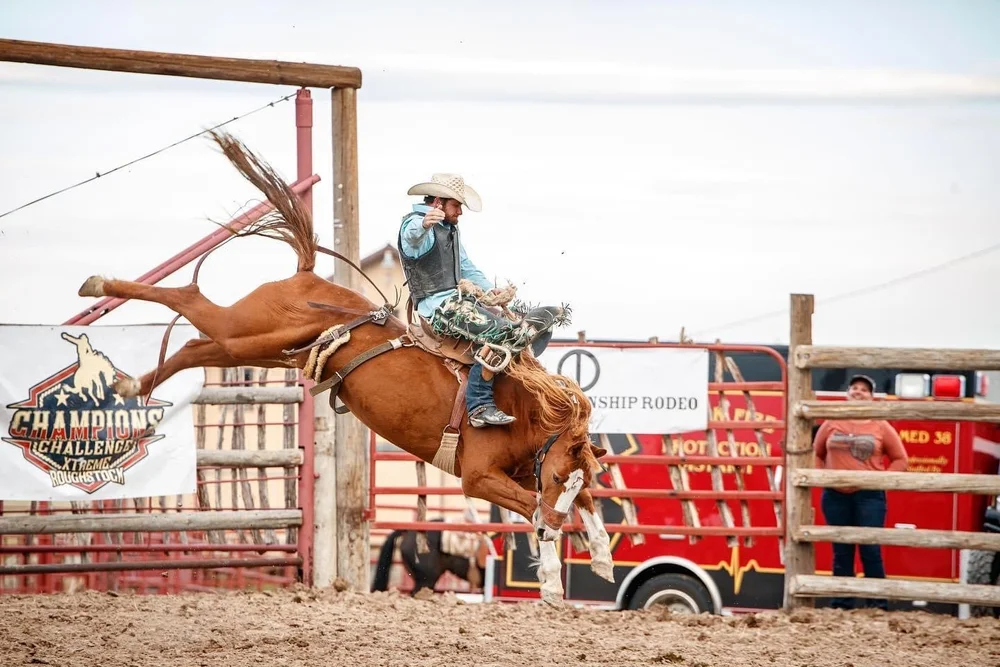 Rodeo rider beside custom emergency vehicle graphics