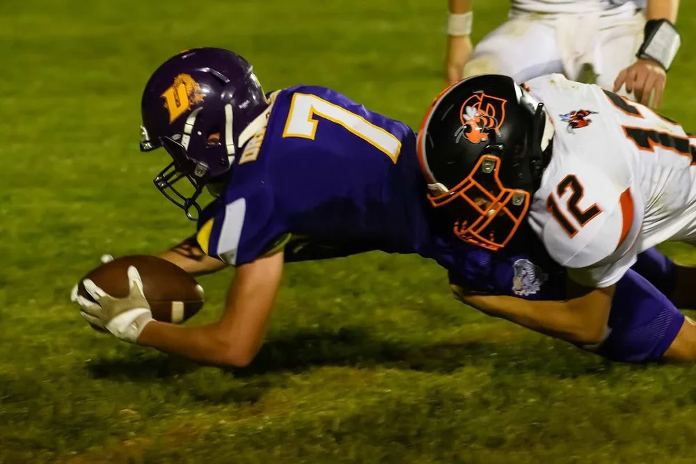 Football players competing in custom school branding