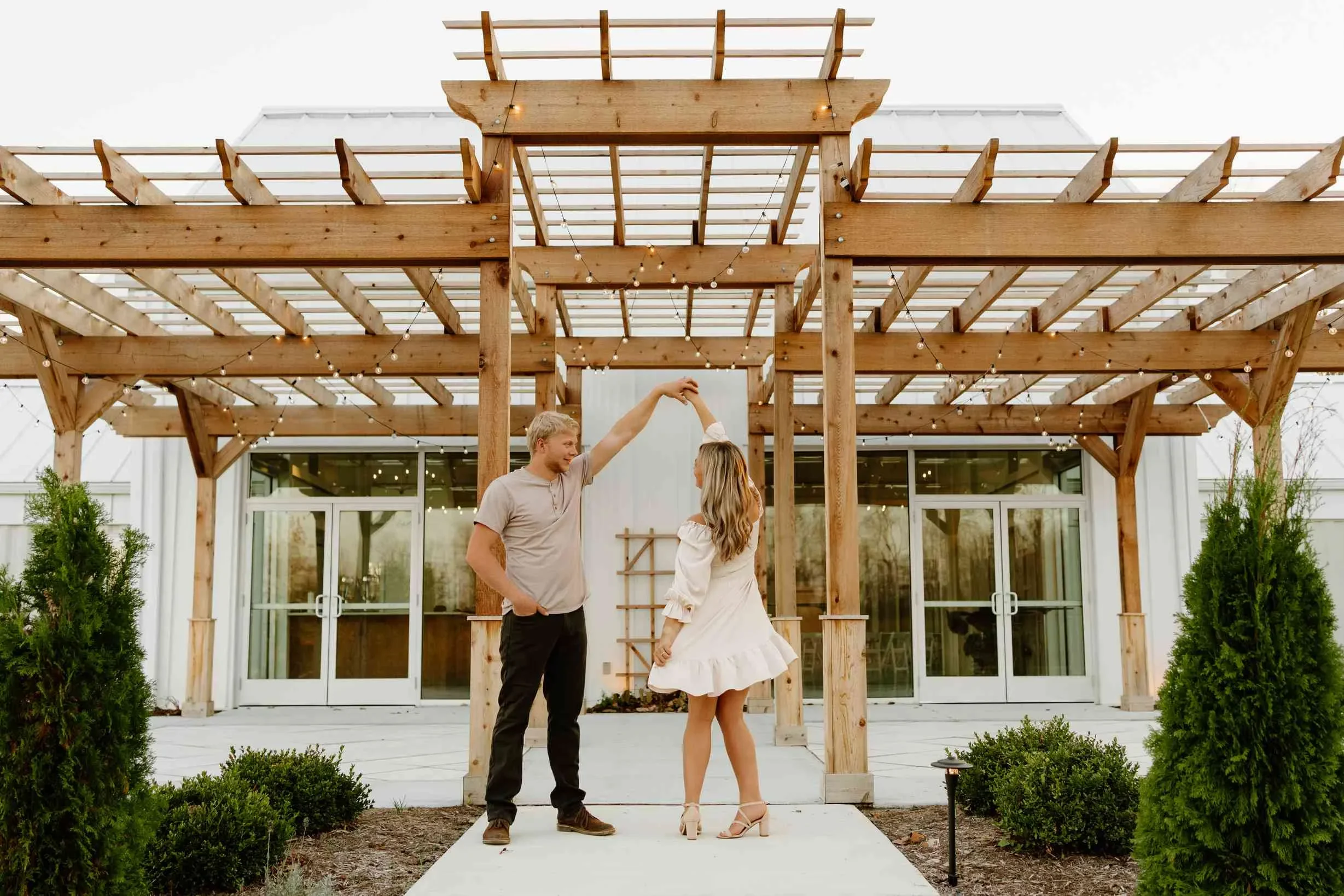 Couple dancing beneath venue pergola