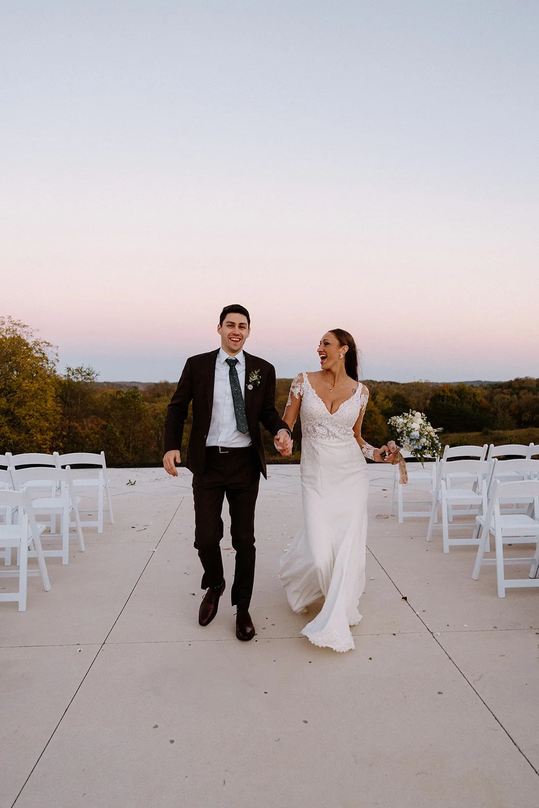 Newlyweds walking after outdoor ceremony