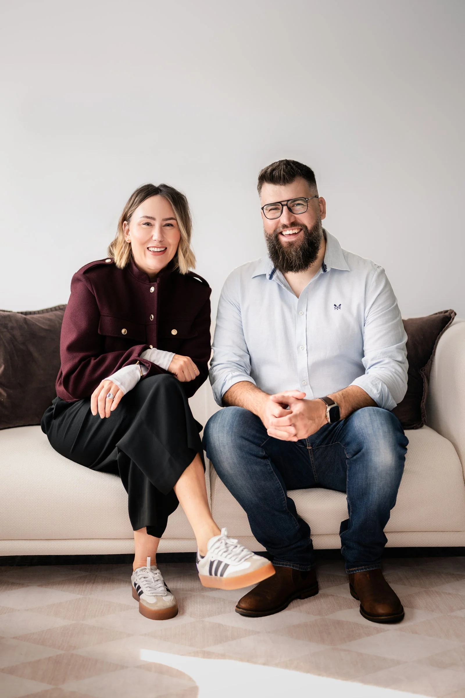 Amie Caldwell and Kristian Harris seated in the Coordinated Solutions office