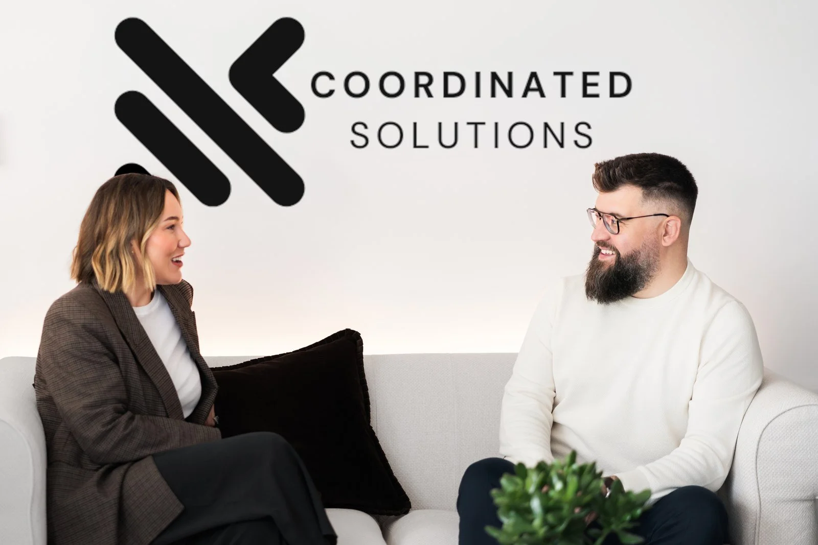 Amie Caldwell and Kristian Harris talking in the Coordinated Solutions office
